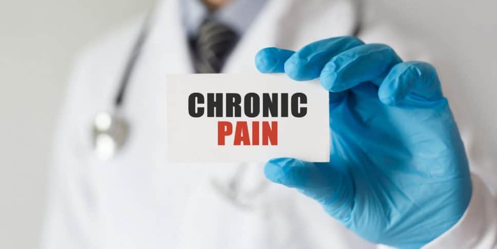 doctor holding chronic pain management card